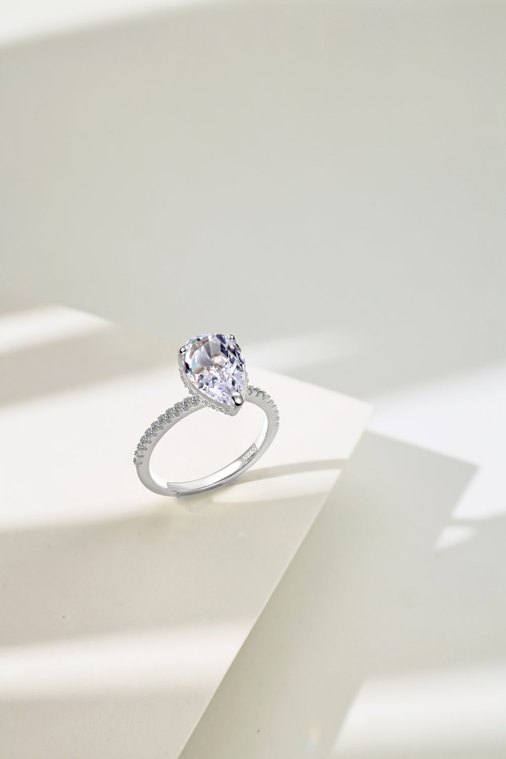 Classic Pear Cut Zirconia on solitaire band half pave Clear