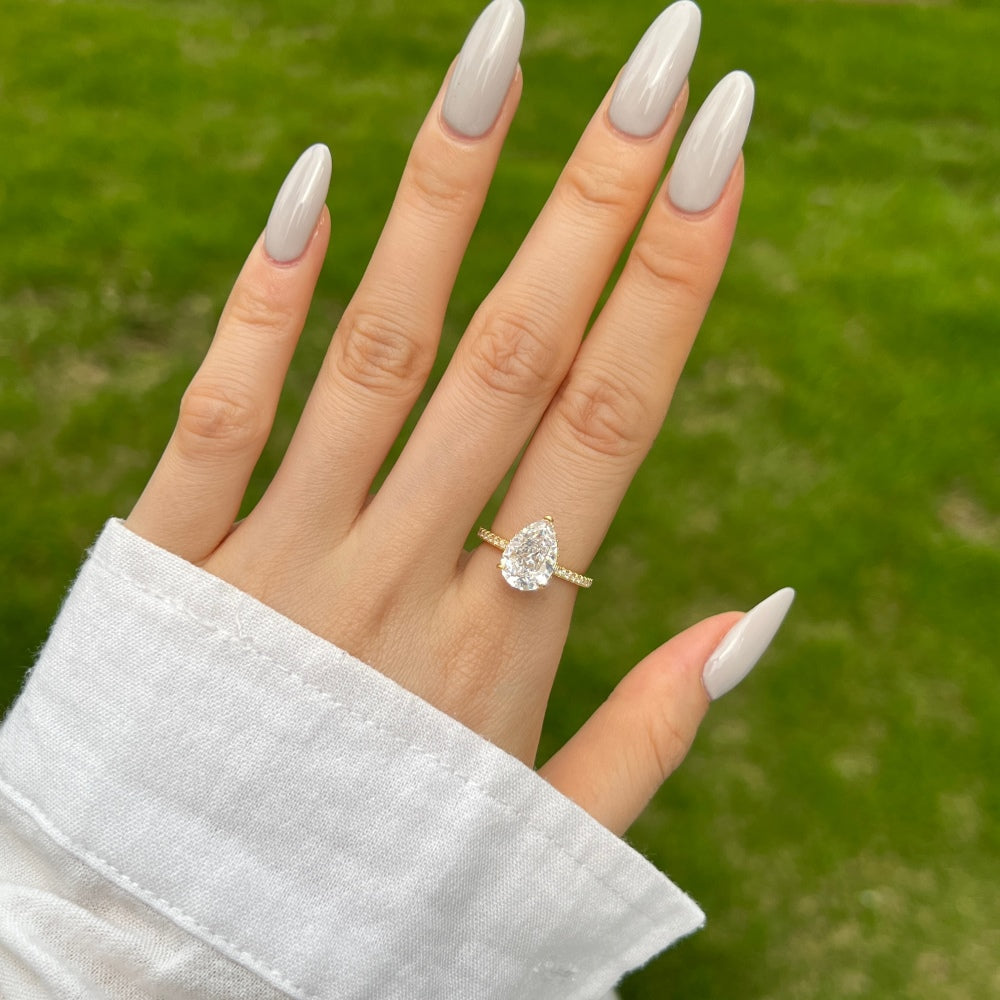 Classic Pear Cut Zirconia on solitaire band half pave gold