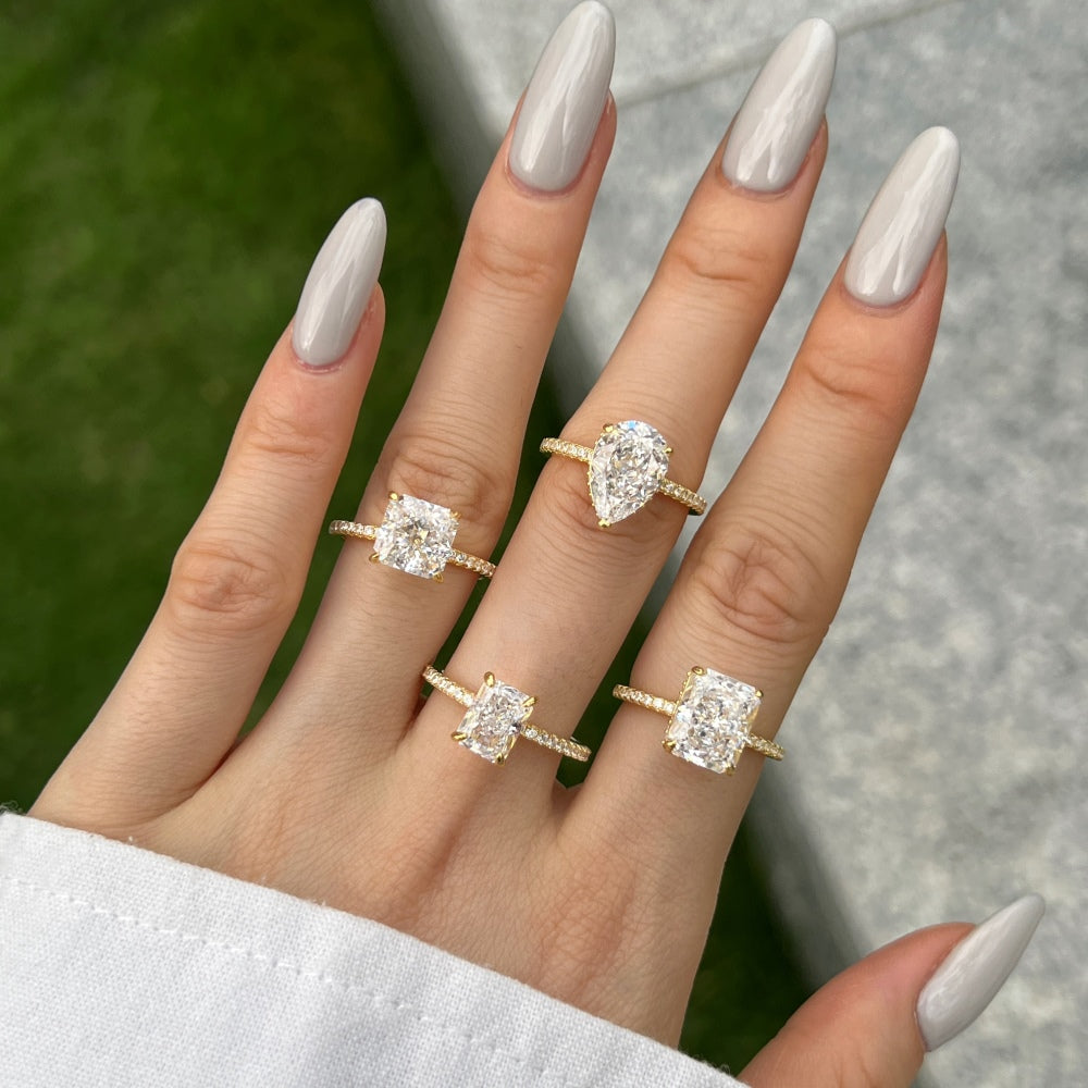 Classic Pear Cut Zirconia on solitaire band half pave gold