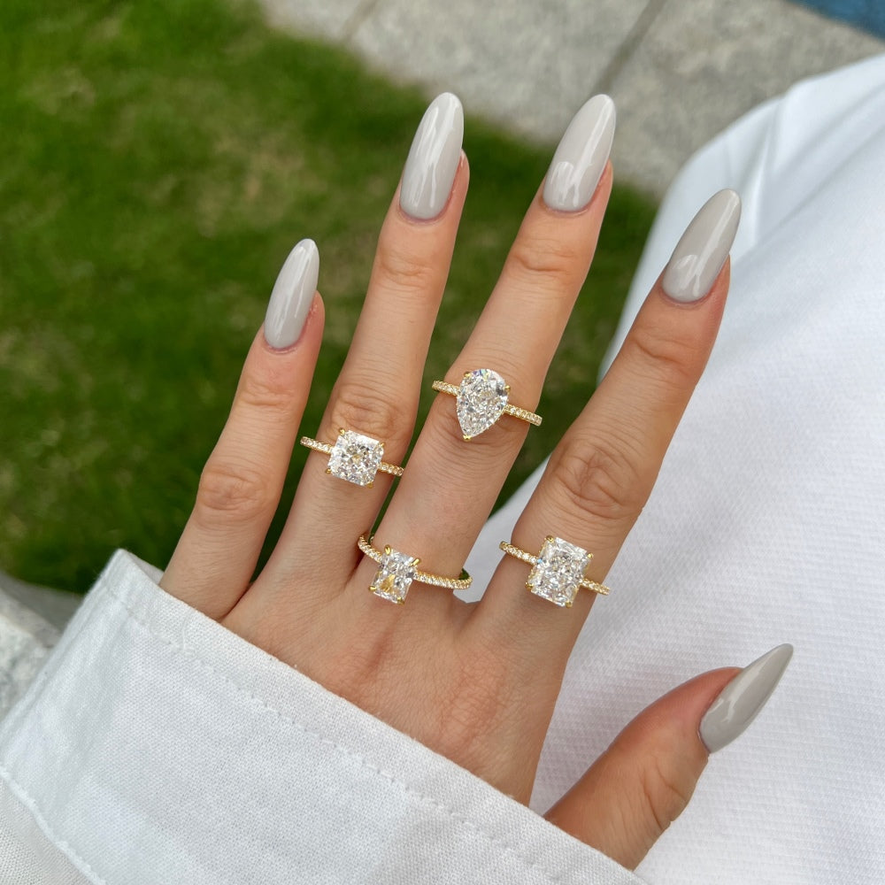 Classic Pear Cut Zirconia on solitaire band half pave gold