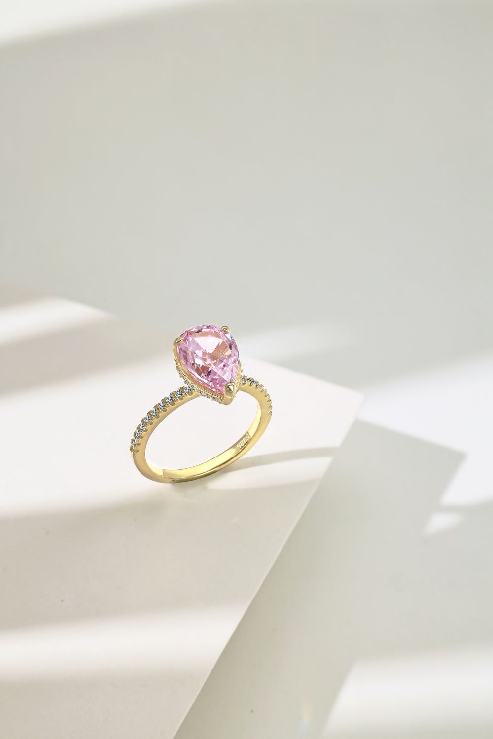 Classic Pear Cut Zirconia on solitaire band half pave gold baby pink