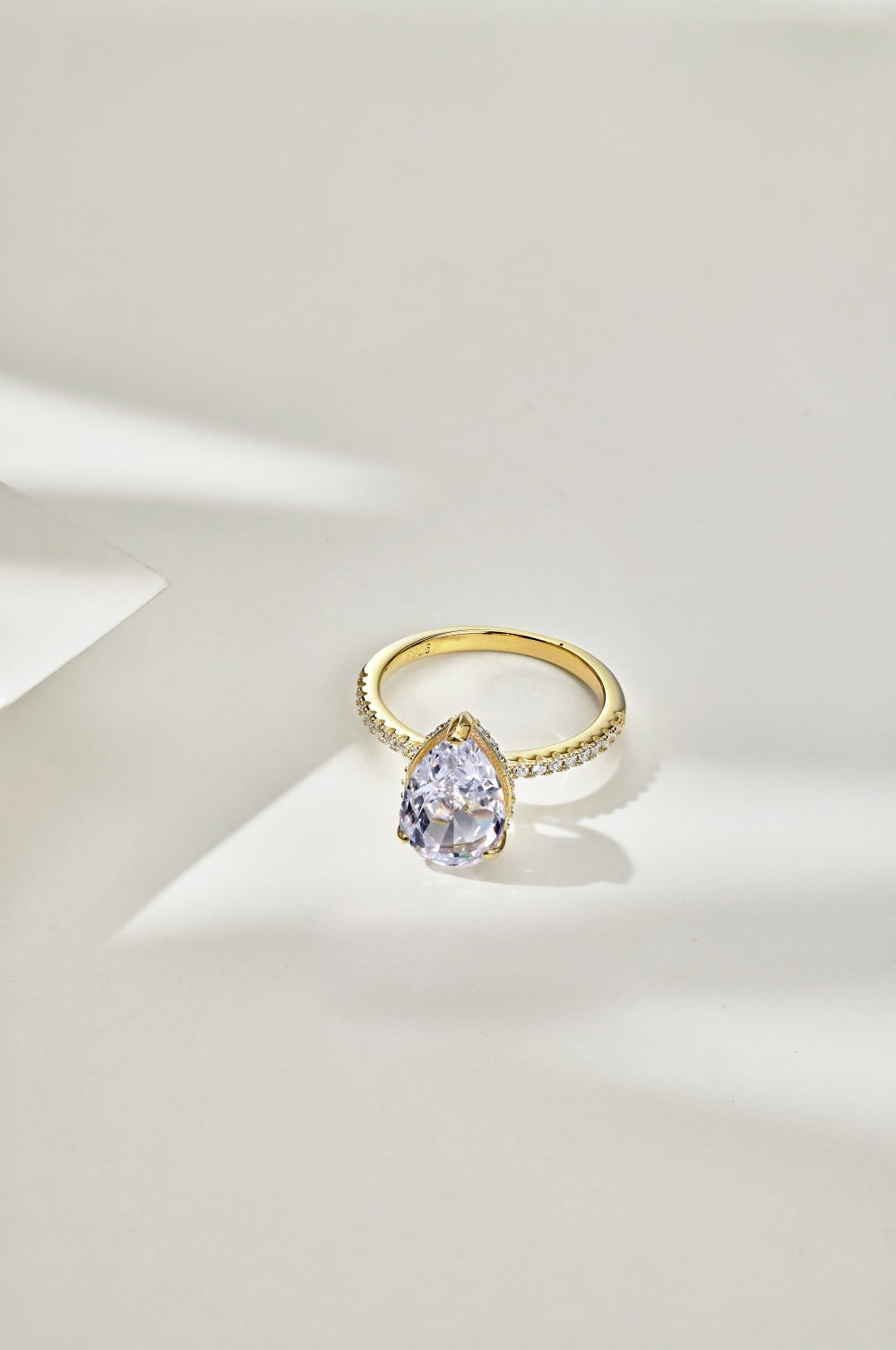 Classic Pear Cut Zirconia on solitaire band half pave gold