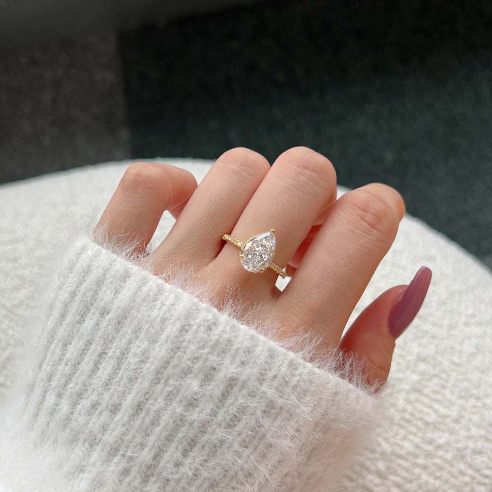 Classic Pear Cut Zirconia on solitaire band half pave gold