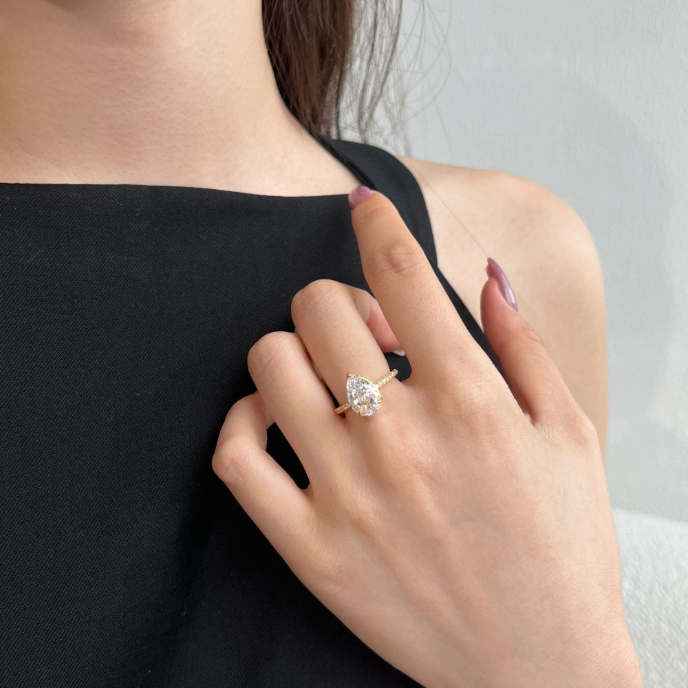 Classic Pear Cut Zirconia on solitaire band half pave gold